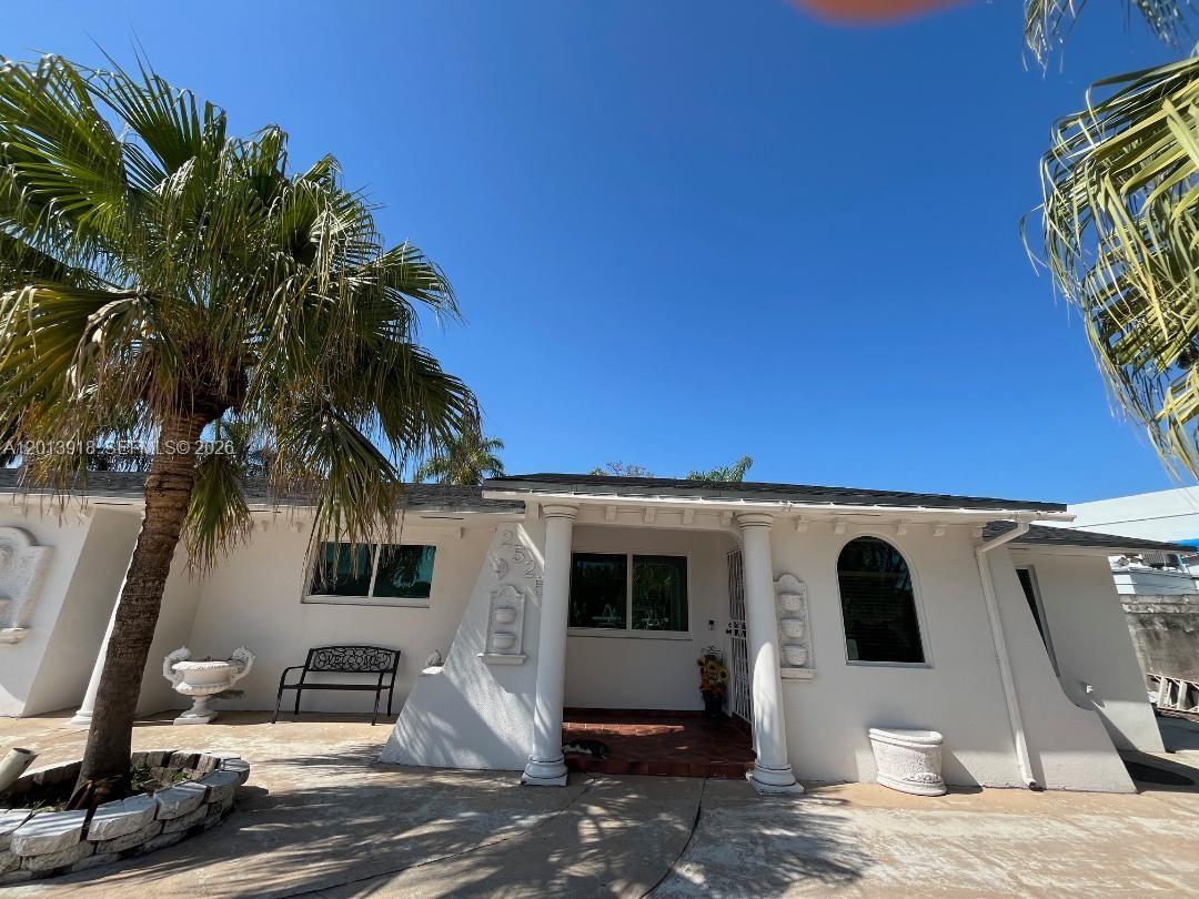 A white single-story house features a covered porch with columns and a palm tree — 2525 SW 107th Ct, Miami FL 33165, MIAMI, FL