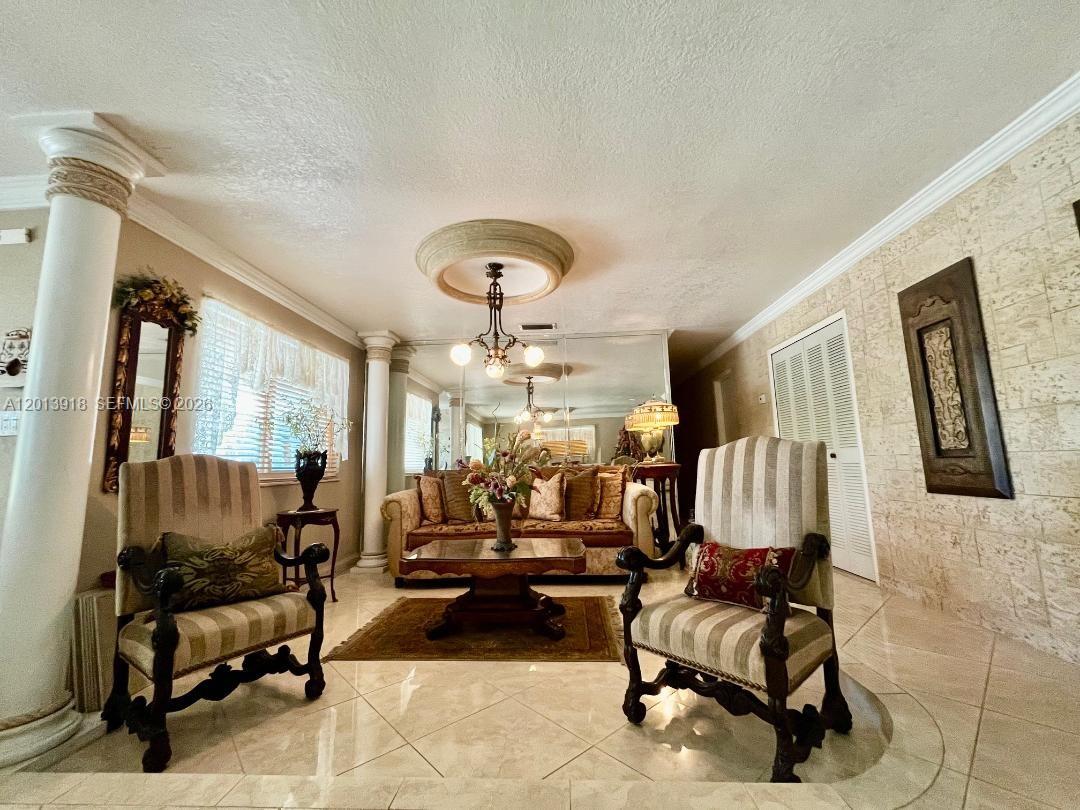A formal living room features tiled floors, decorative columns, a mirrored wall, and traditional furniture — 2525 SW 107th Ct, Miami FL 33165, MIAMI, FL