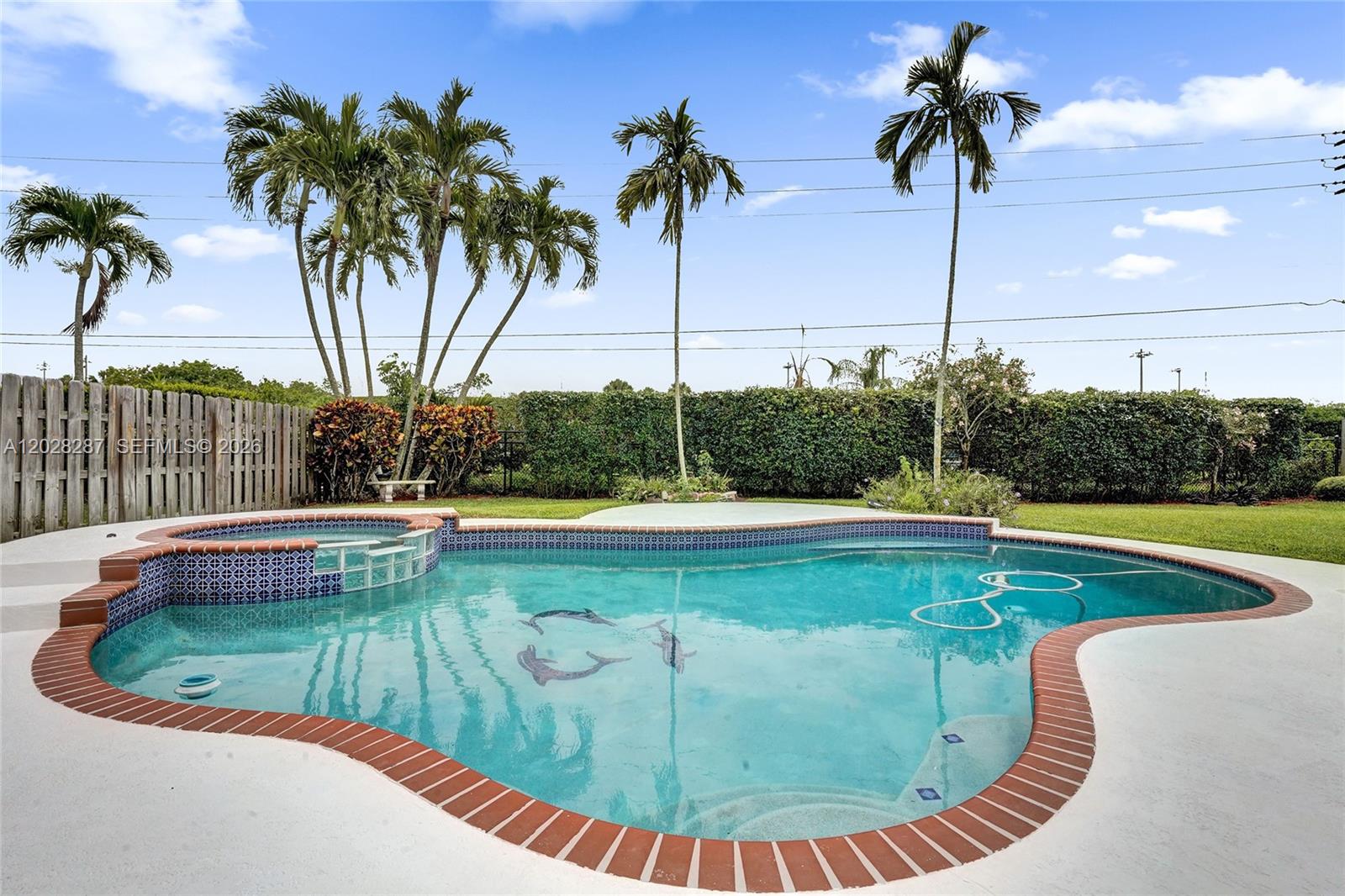 An open double door leads from a tiled porch into a bright, spacious living area — 8860 Southern Orchard Rd S, Davie FL 33328, DAVIE, FL