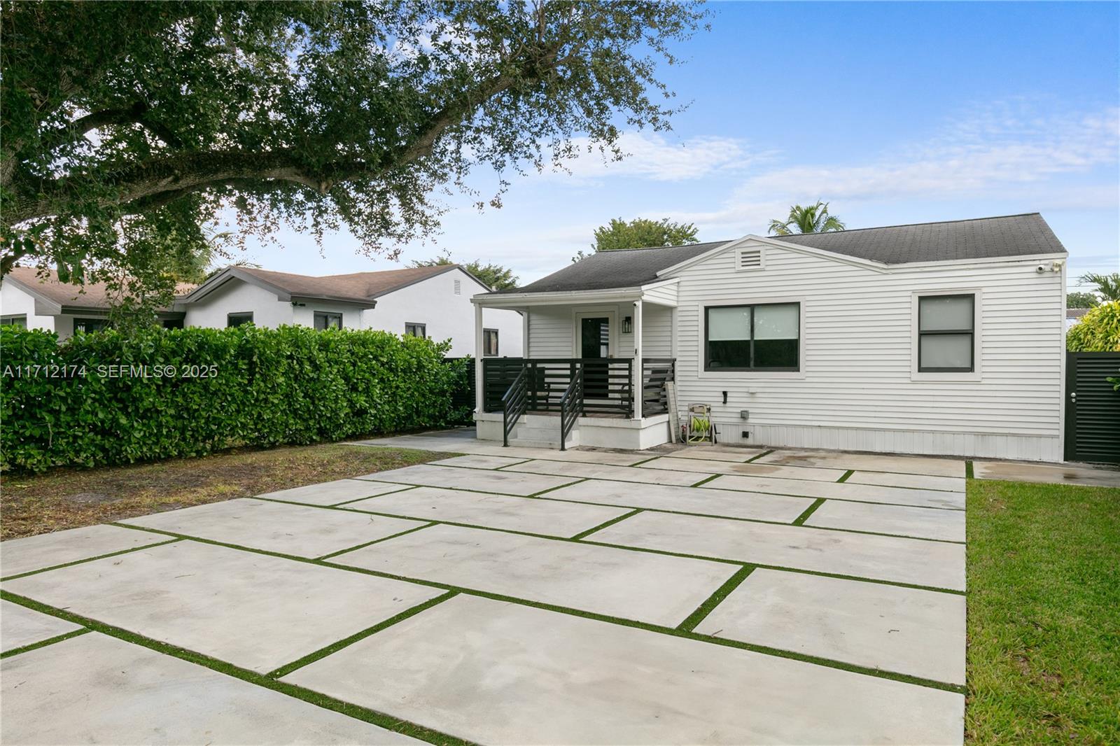 A white house with a concrete paver driveway and a small front porch — 341 NW 67th Ave, Miami Springs FL 33166, MIAMI SPRINGS, FL