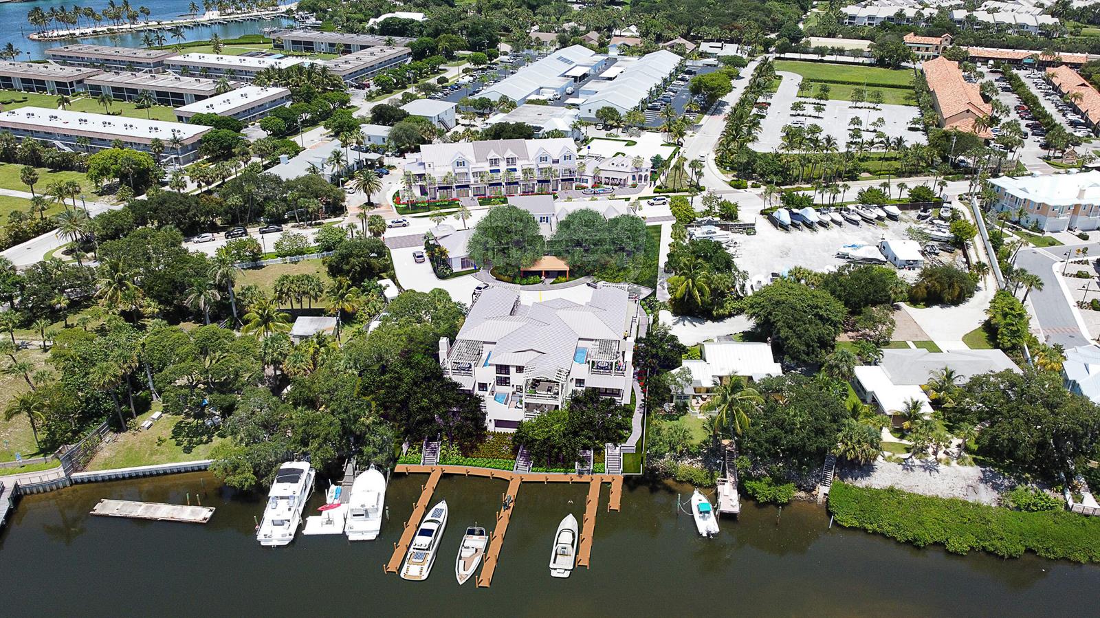 An aerial view of a waterfront house with a private dock and several moored boats — 18011 N Highway A1a, Jupiter FL 33477, JUPITER, FL