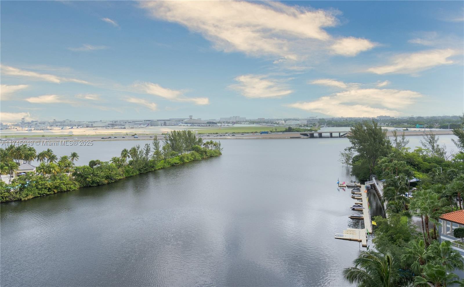An elevated view shows a waterway, a boat dock, and an airport in the distance — 5091 NW 7th St # 1001, Miami FL 33126, MIAMI, FL