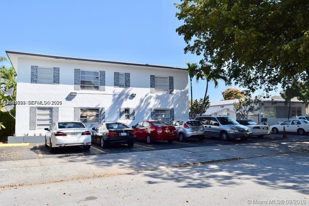 A two-story white apartment building with a parking lot in front — 1843 Dewey St # 104, Hollywood FL 33020, HOLLYWOOD, FL