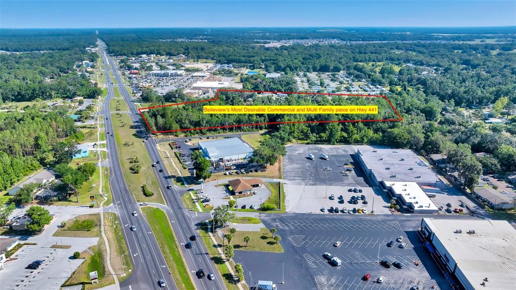 An aerial view shows a rectangular plot of land outlined in red near a highway — 4799 SE 106TH PLACE ROAD, BELLEVIEW, FL