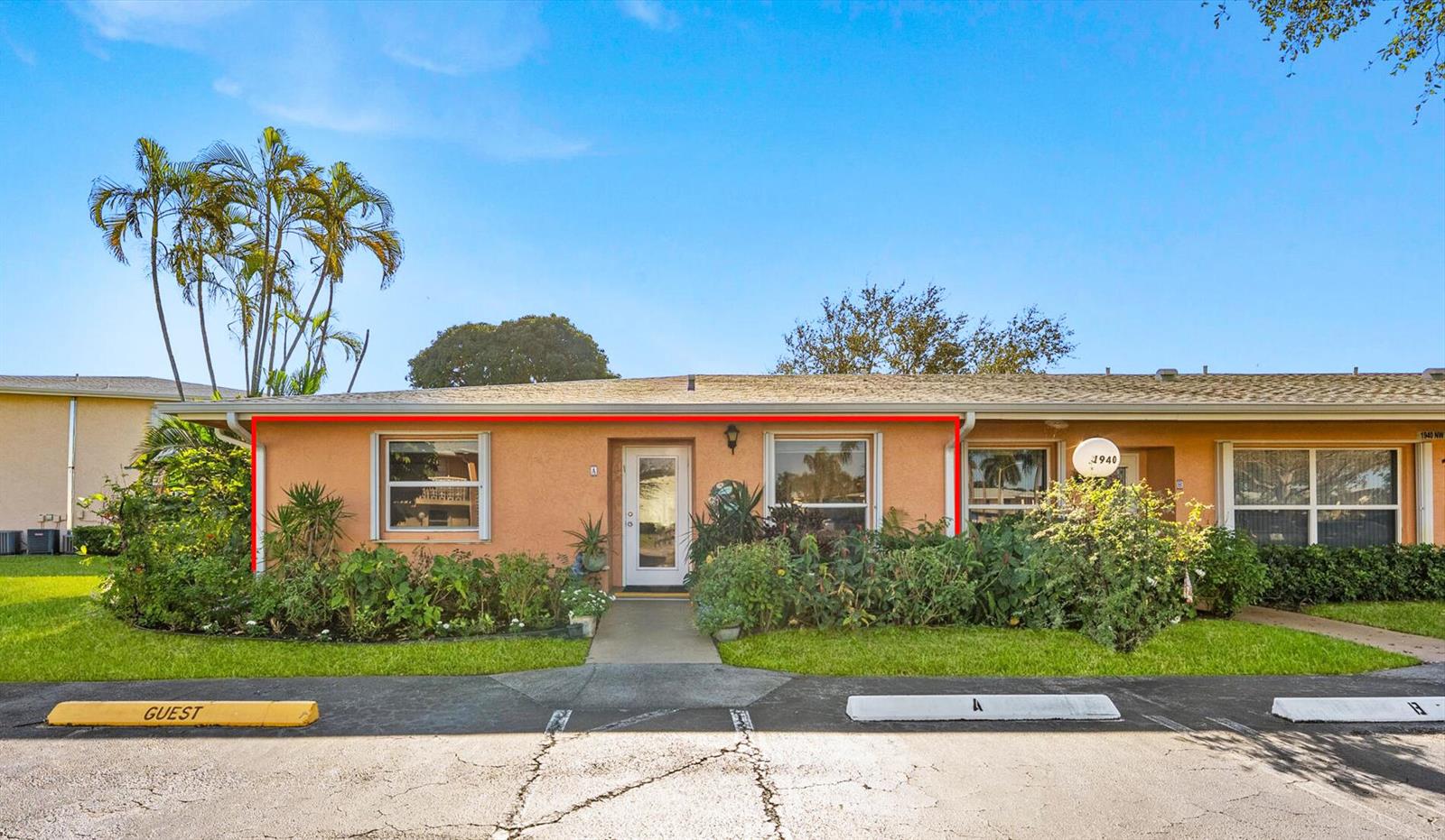 A single-story peach-colored residential building with a front entrance, windows, and landscaping — 1940 NW 13th Street # a, Delray Beach FL 33445, DELRAY BEACH, FL