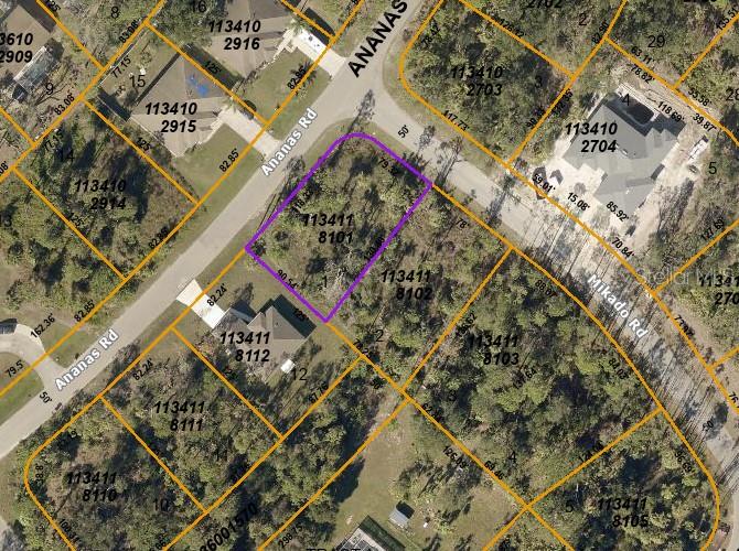 This is an aerial map showing a highlighted vacant lot located at a street intersection — MIKADO ROAD, NORTH PORT, FL