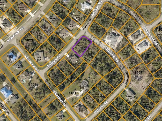 This is an aerial map view showing a highlighted vacant residential lot in a neighborhood — MIKADO ROAD, NORTH PORT, FL