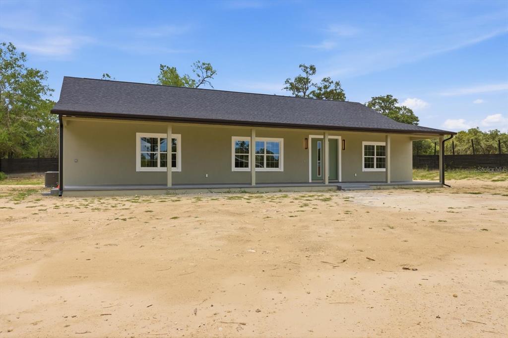 A single-story house with a covered front porch and a dark shingled roof — 5970 W INLAND, DUNNELLON, FL