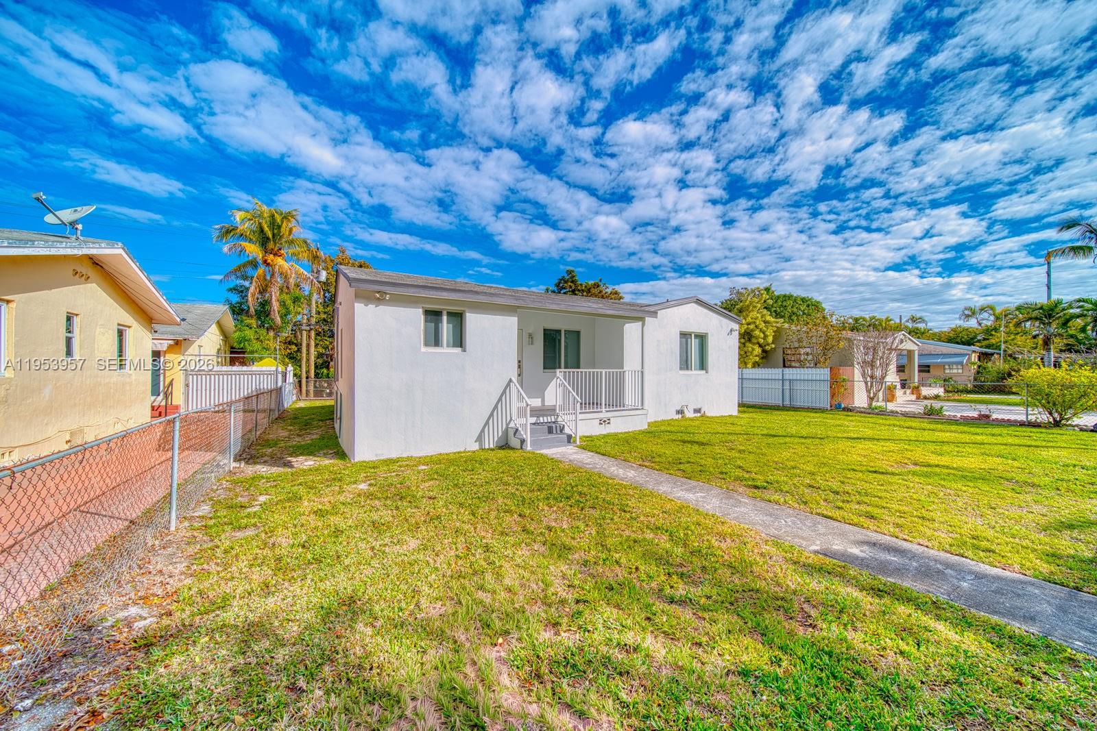 A white single-story house with a front porch sits on a grassy lot — 4345 SW 5th Ter, Miami FL 33134, MIAMI, FL