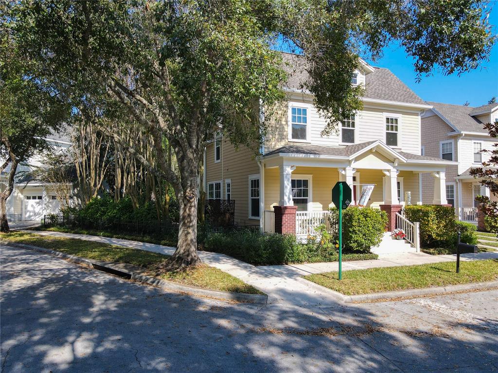 A yellow two-story house with a front porch and a detached garage — 1101 BANKS ROSE COURT, CELEBRATION, FL