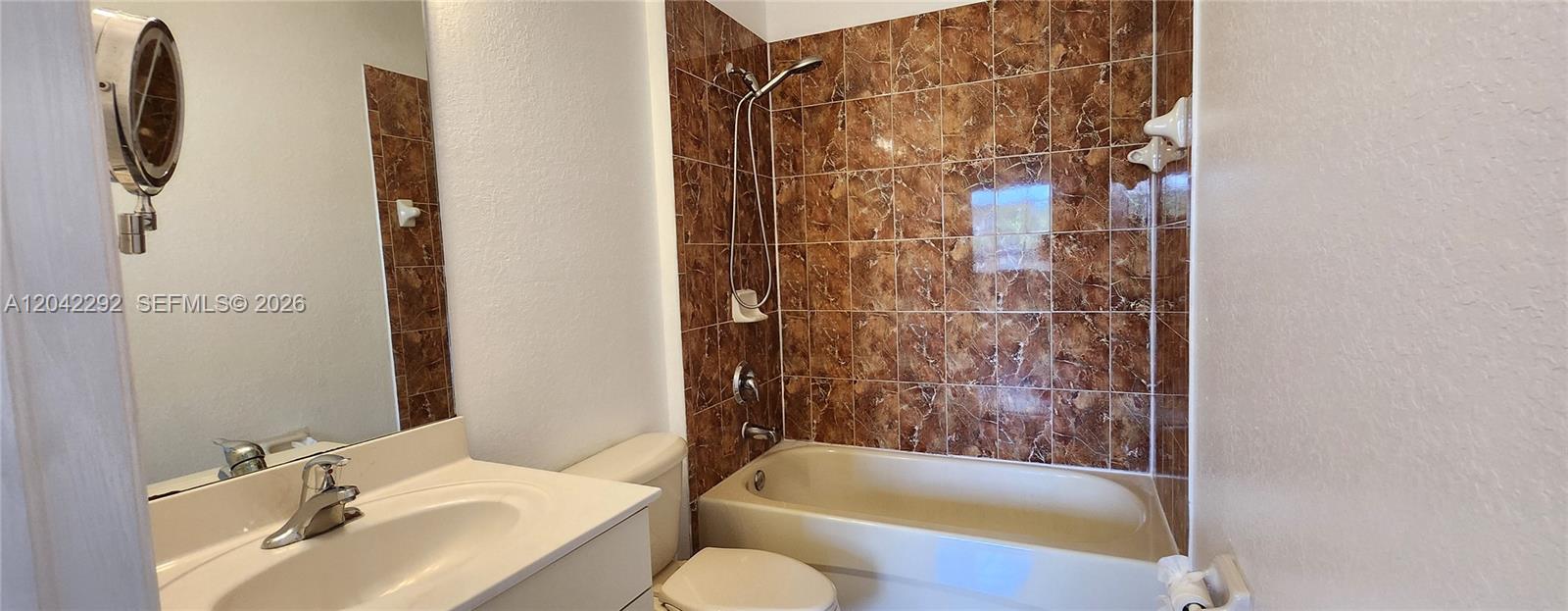 A bathroom features a vanity with a sink, a toilet, and a tiled shower-tub combination — 10949 SW 181 TE # 0, Miami FL 33157, MIAMI, FL
