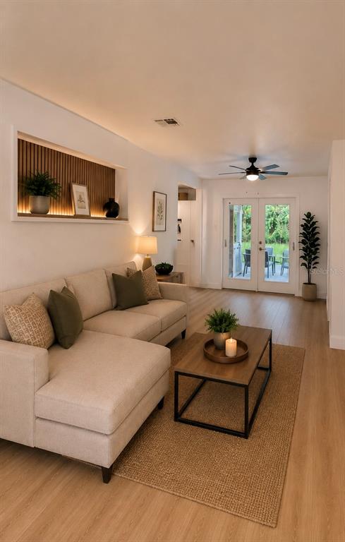 A living room features a beige sectional sofa, a wooden coffee table, and a recessed wall niche — 800 MARY STREET, EDGEWATER, FL