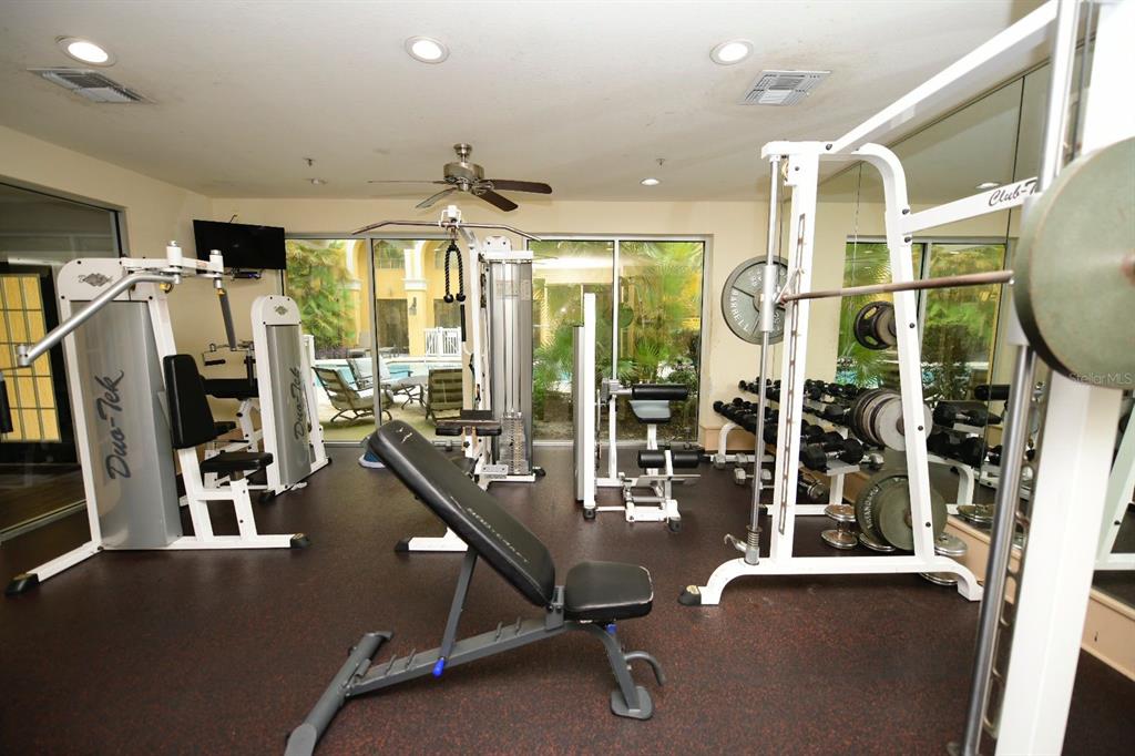 A gym features various weight machines, a weight bench, and a rack of dumbbells — 860 N ORANGE AVENUE UNIT 213, ORLANDO, FL