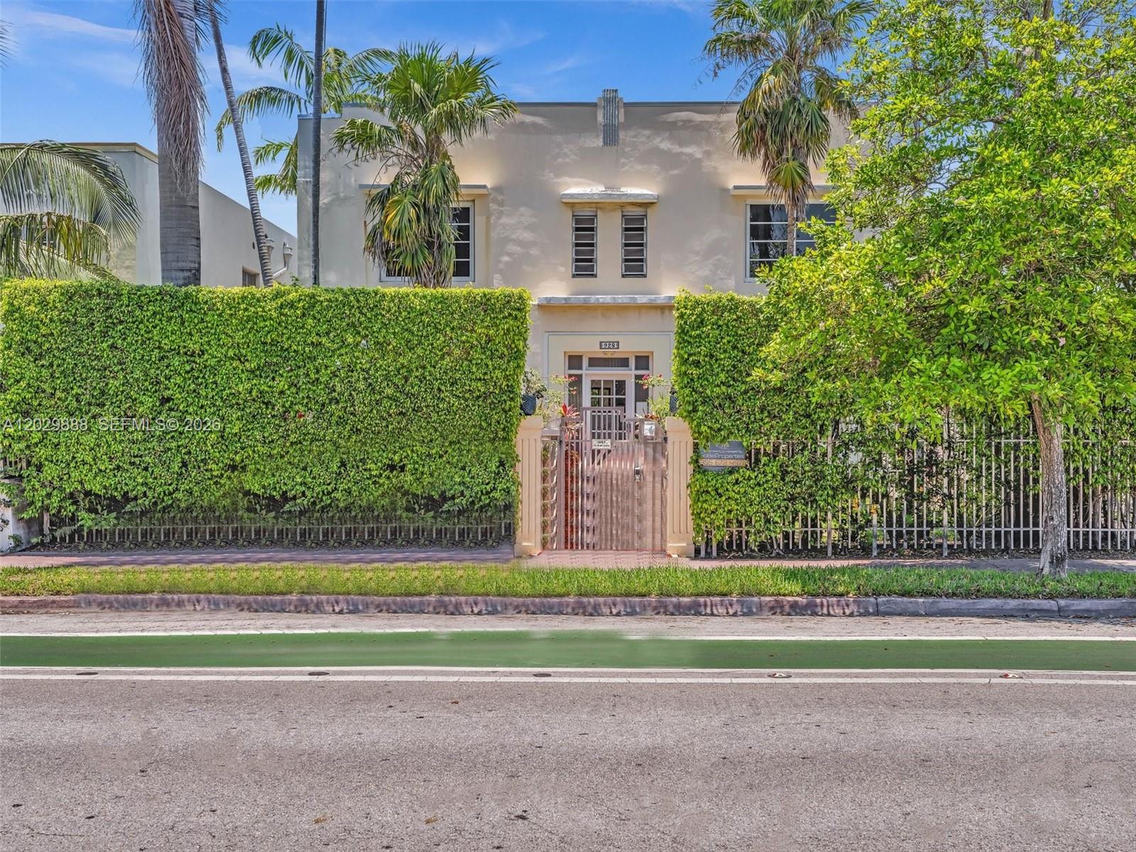 A two-story Art Deco building is fronted by a tall hedge and a gated entrance — 928 Euclid Ave # 2, Miami Beach FL 33139, MIAMI BEACH, FL