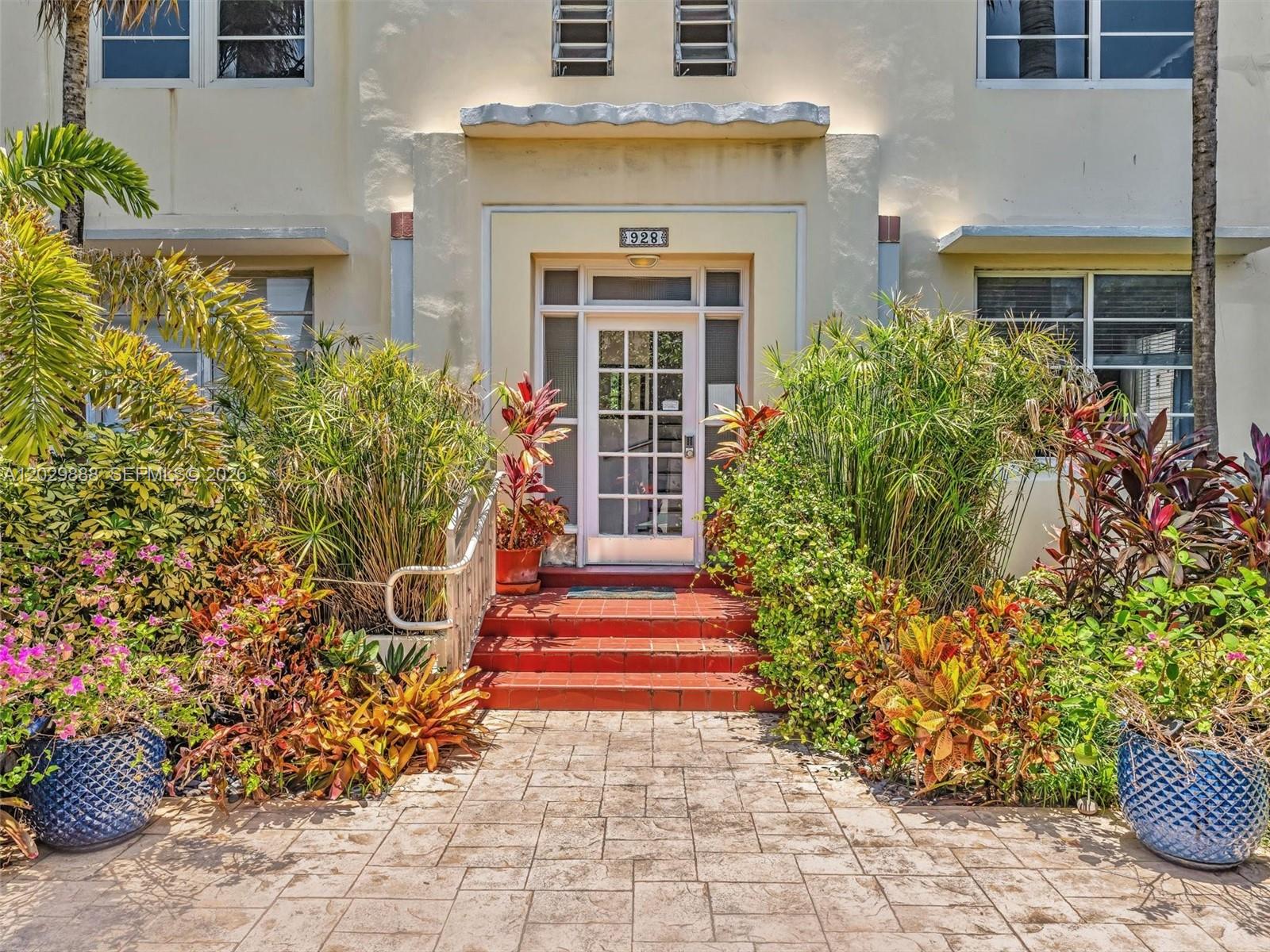 A paved walkway leads to the red-stepped entrance of a building with lush tropical landscaping — 928 Euclid Ave # 2, Miami Beach FL 33139, MIAMI BEACH, FL