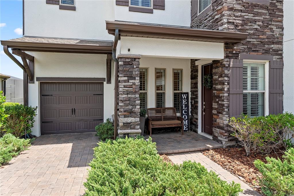 A kitchen features dark wood cabinets, granite countertops, a subway tile backsplash, and a central island — 906 SHERBOURNE CIRCLE, LAKE MARY, FL