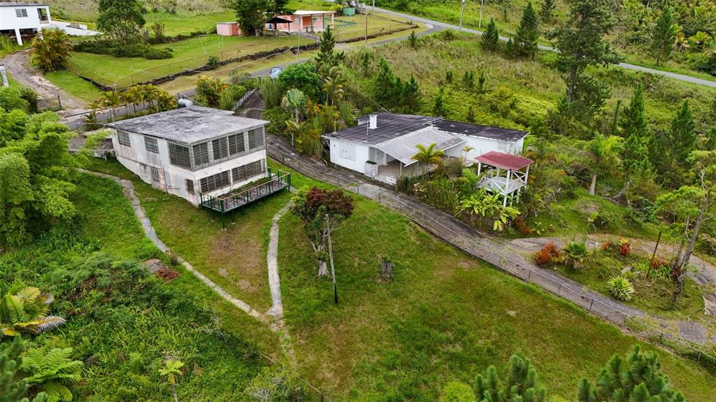 An aerial view shows two houses on a grassy hillside with a small gazebo nearby — #143 BO ANON, UNIT 5, PONCE, PR