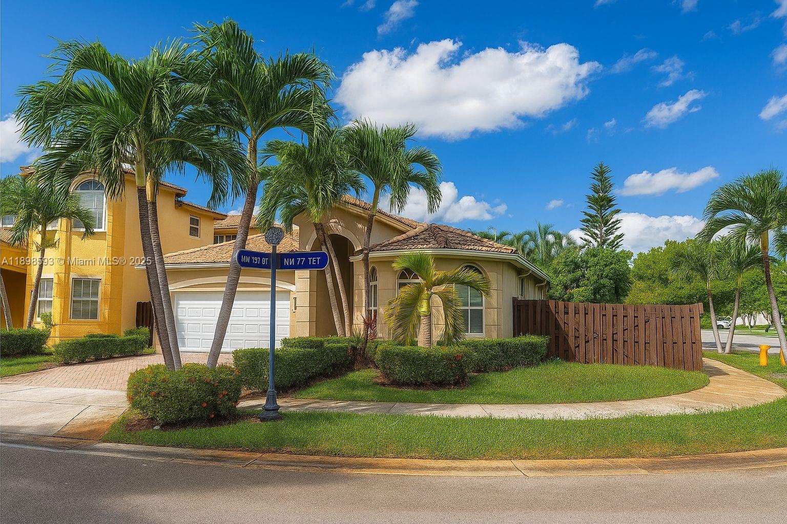 A two-story house with a beige stucco exterior, a tile roof, and palm trees — 11141 NW 77th Ter, Doral FL 33178, DORAL, FL