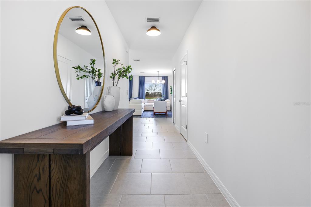 A two-story house with light siding, a paved driveway, and a two-car garage — 3821 AMBERSWEET CROSSING, PARRISH, FL