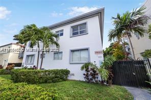 A two-story white building with palm trees and a black metal gate in front — 820 15th St # 104, Miami Beach FL 33139, MIAMI BEACH, FL