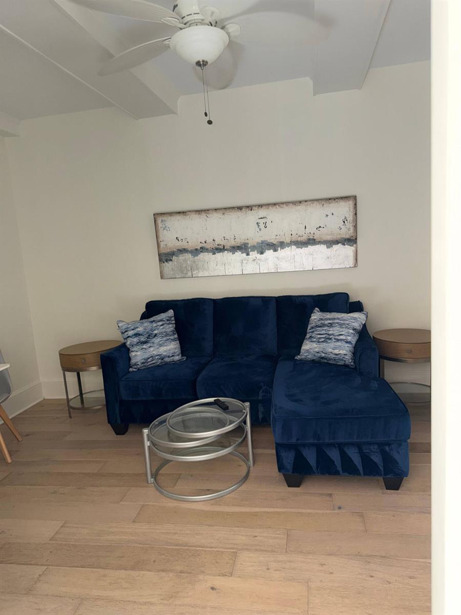 A living room features a blue velvet sectional sofa, two round side tables, and glass tables — 301 Chilean Avenue # 0080, Palm Beach FL 33480, PALM BEACH, FL