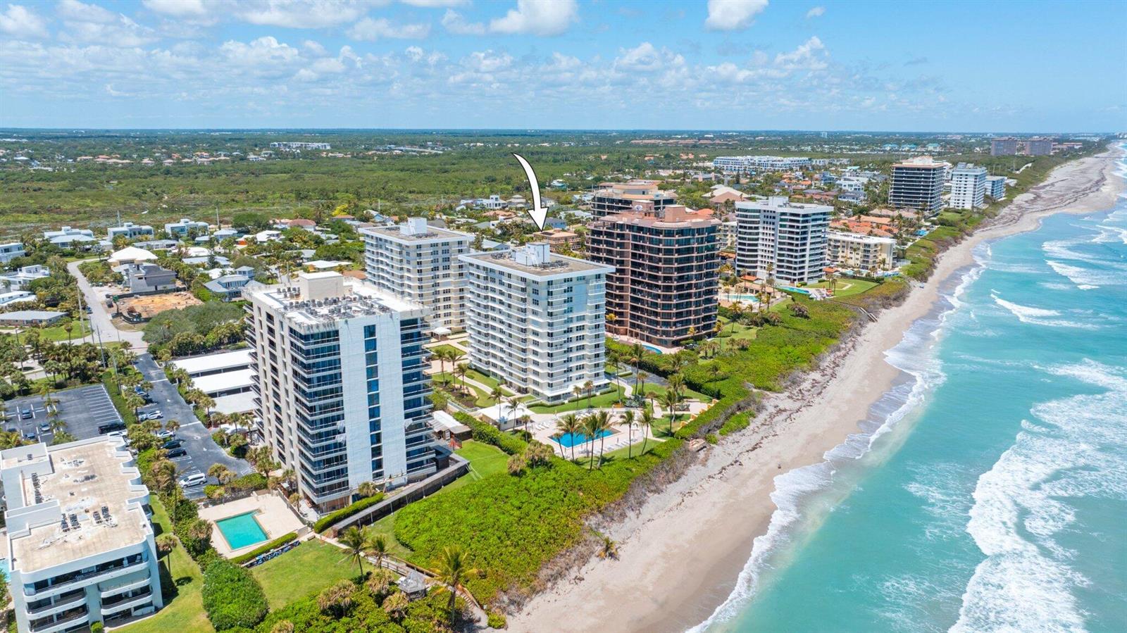 An aerial view of several beachfront high-rise condominium buildings along a sandy coastline — 500 Ocean Drive, Juno Beach FL 33408, JUNO BEACH, FL