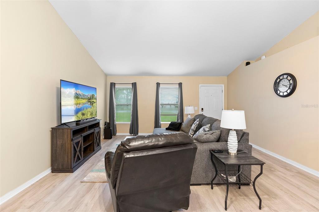 A living room features a television on a console, a sectional sofa, and a recliner — 3750 SW 127TH LANE ROAD, OCALA, FL