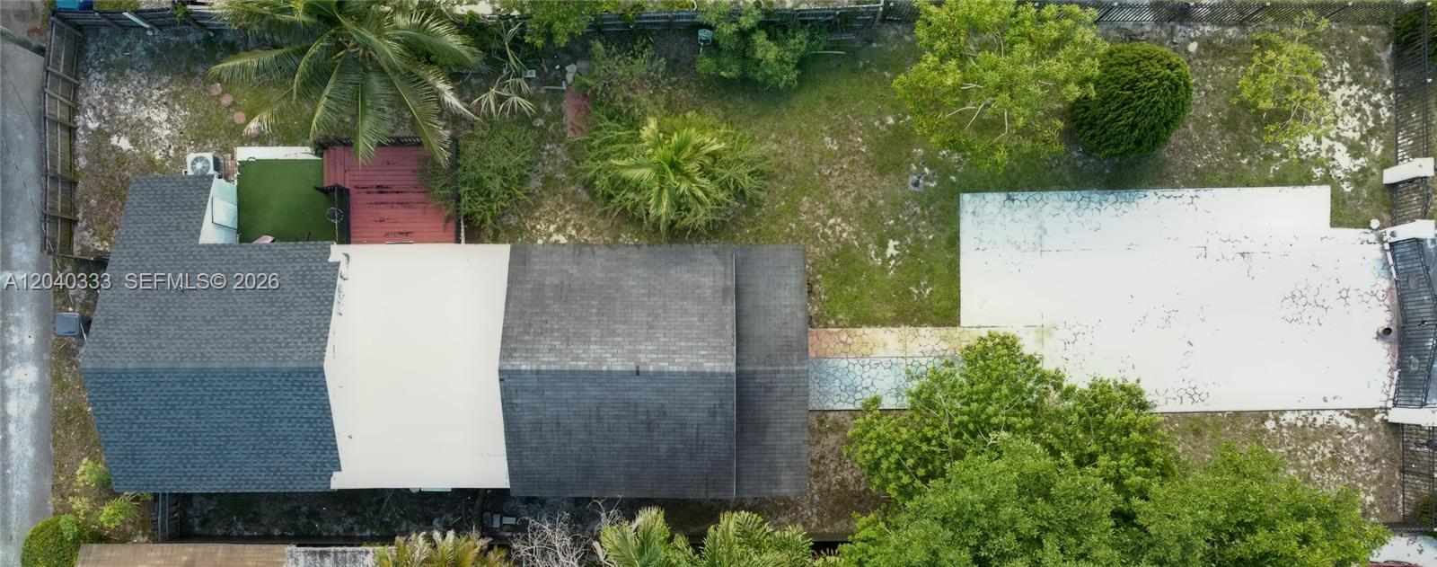 An aerial view shows a house with a dark roof, a deck, and a driveway — 2218 Harding St, Hollywood FL 33020, HOLLYWOOD, FL