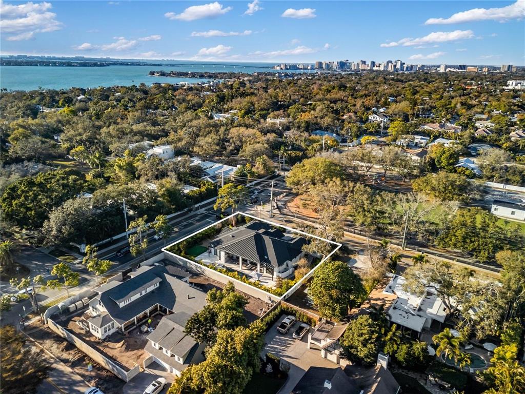 An aerial view shows a single-story house with a dark roof outlined in white — 1800 WEBBER STREET, SARASOTA, FL
