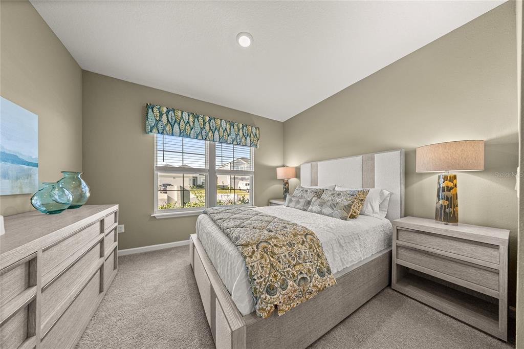 A bedroom features a queen bed, two nightstands, a dresser, and a window with valance — 19376 SW 77TH LOOP, DUNNELLON, FL