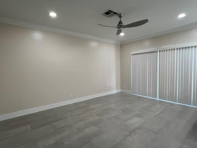 An empty room features light-colored walls, gray tile flooring, a ceiling fan, and vertical blinds — 239 Leland Lane, FL 33463, FL