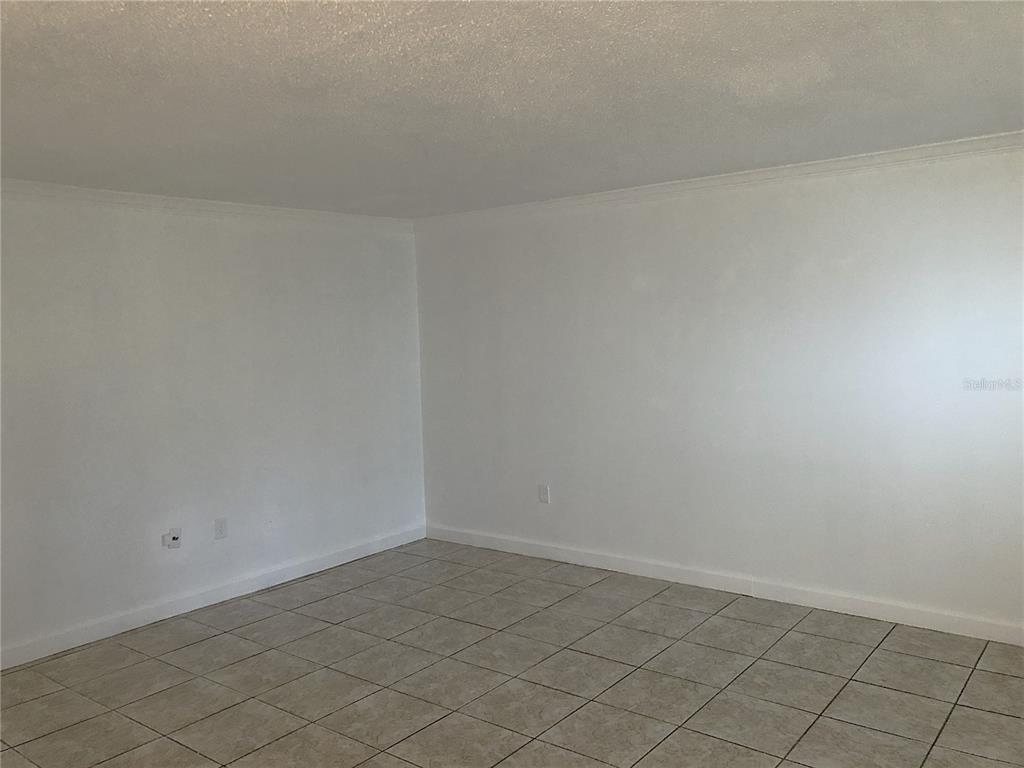 An empty room with white walls and light-colored square floor tiles — 2545 OAK PARK WAY UNIT 118, ORLANDO, FL