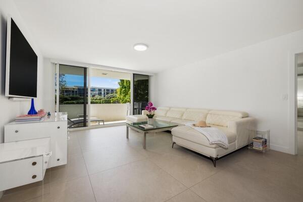 A bright living room features white tile floors, a white sectional sofa, and a balcony — 2773 S Ocean Boulevard # 214, Palm Beach FL 33480, PALM BEACH, FL