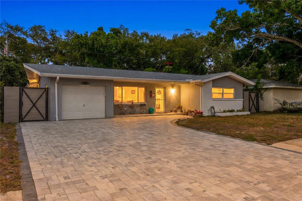A single-story house with a paved driveway, a one-car garage, and a front patio — 1144 WOODBROOK DRIVE, LARGO, FL