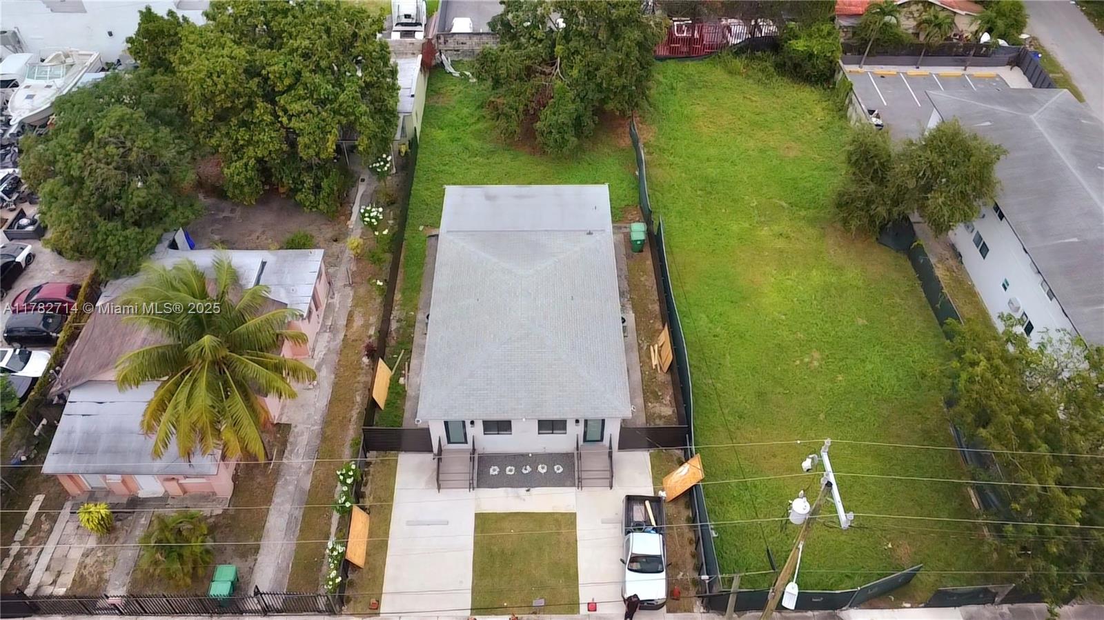 An aerial view shows a small rectangular house with a gray roof on a lot — 683 & 681 & 679 NW 30th St, Miami FL 33127, MIAMI, FL