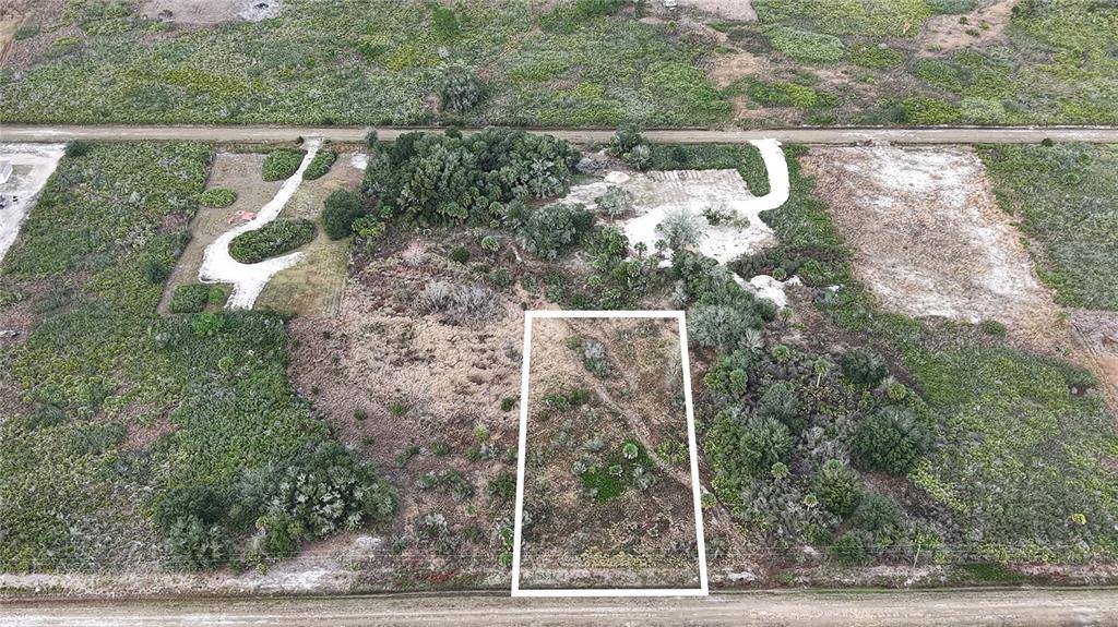 An aerial view shows a rectangular plot of land outlined in white amidst natural vegetation — 21867 NW 276TH STREET, OKEECHOBEE, FL