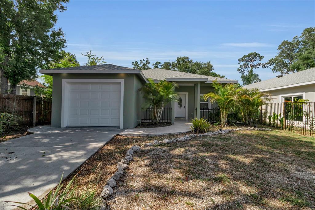 A single-story house with a green exterior, a white garage door, and a front walkway — 1536 25TH STREET, SARASOTA, FL