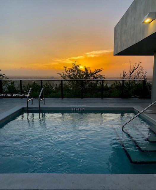 A room with gray tile flooring features a large sliding glass door overlooking city skyscrapers — 1600 NE 1st Ave # 2508, Miami FL 33132, MIAMI, FL