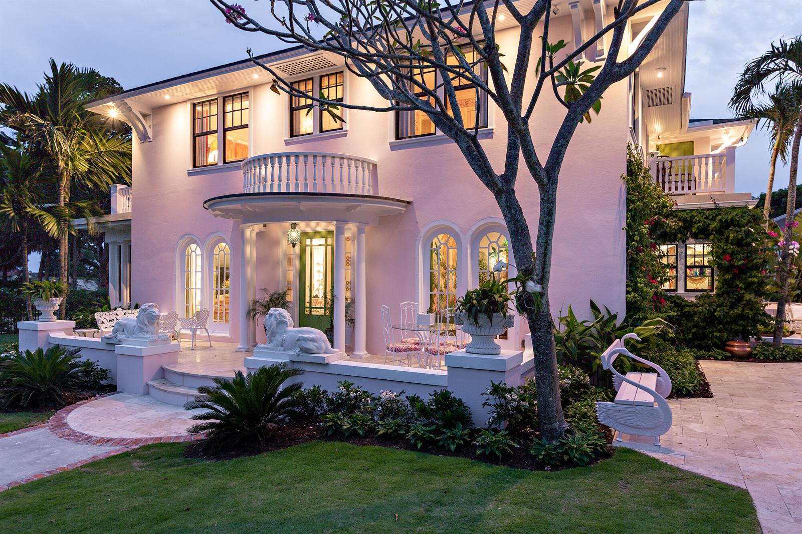 A two-story pink house with a columned porch, lion statues, and a swan-shaped bench — 3101 Washington Road, West Palm Beach FL 33405, WEST PALM BEACH, FL