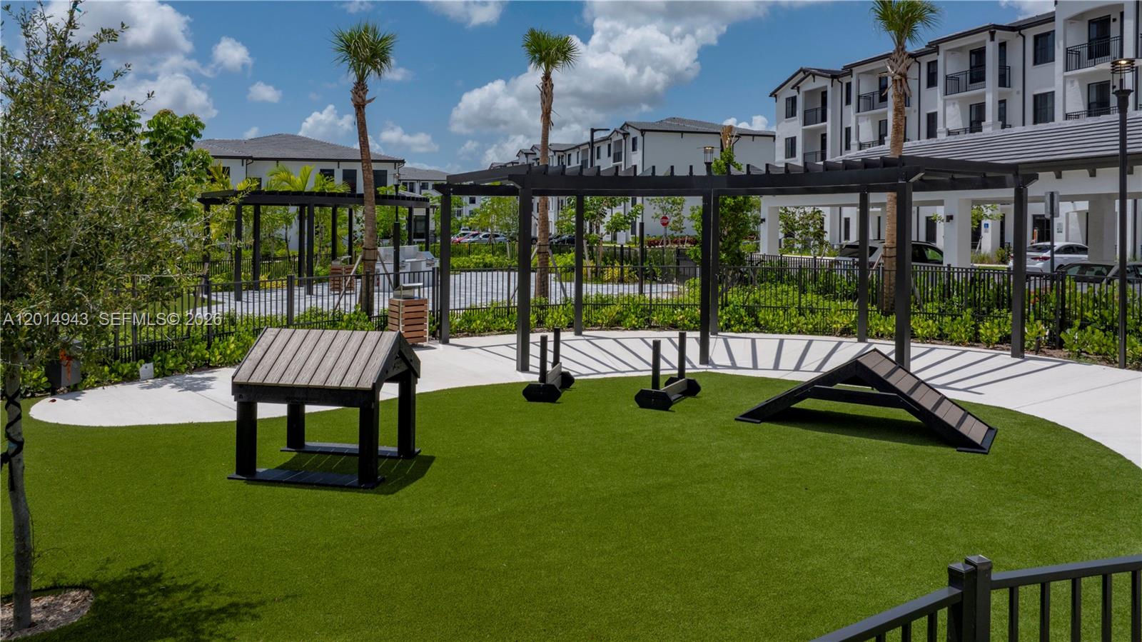 A fenced dog park features artificial turf, agility equipment, and a shaded pergola area — 9030 SW 158th Ave # 209, Miami FL 33196, MIAMI, FL