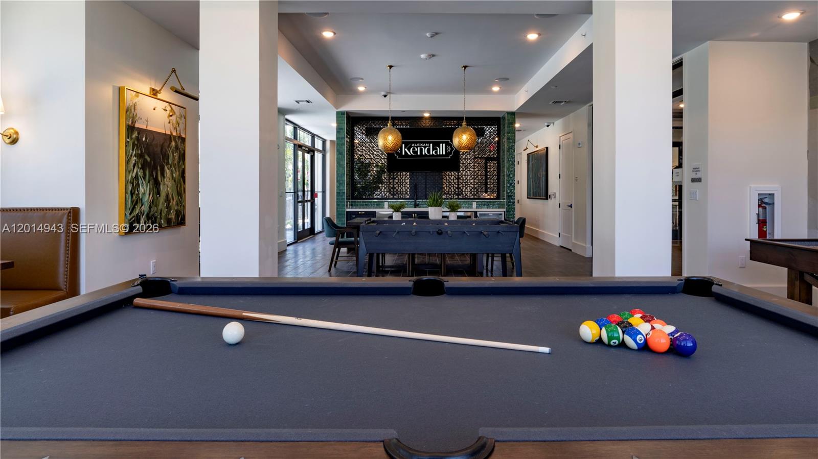 A game room features a pool table in the foreground and a foosball table beyond — 9030 SW 158th Ave # 209, Miami FL 33196, MIAMI, FL