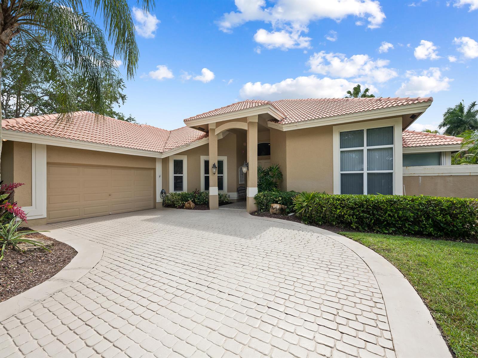 A backyard swimming pool with a brick patio and outdoor dining area at sunset — 1207 Manor Drive S, Weston FL 33326, WESTON, FL