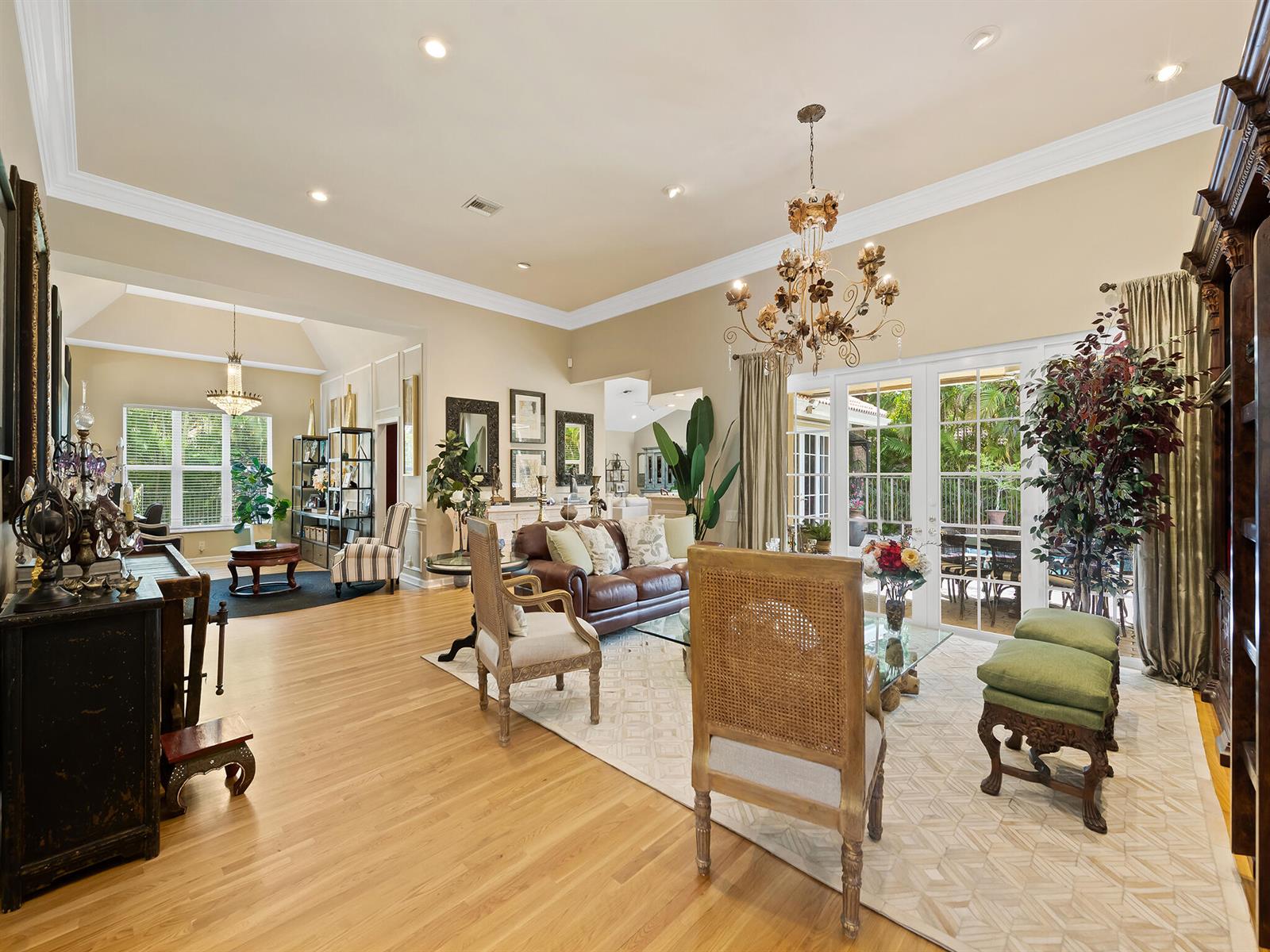 A tan house with a tiled roof, arched entryway, and a paved driveway — 1207 Manor Drive S, Weston FL 33326, WESTON, FL