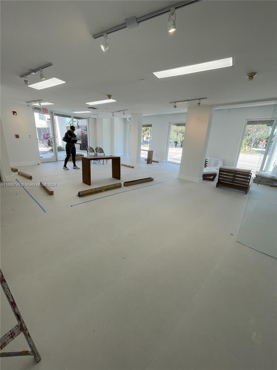 This commercial space features white walls, large windows, recessed lighting, and light-colored tile flooring — 5050 Biscayne Blvd # 100, Miami FL 33137, MIAMI, FL