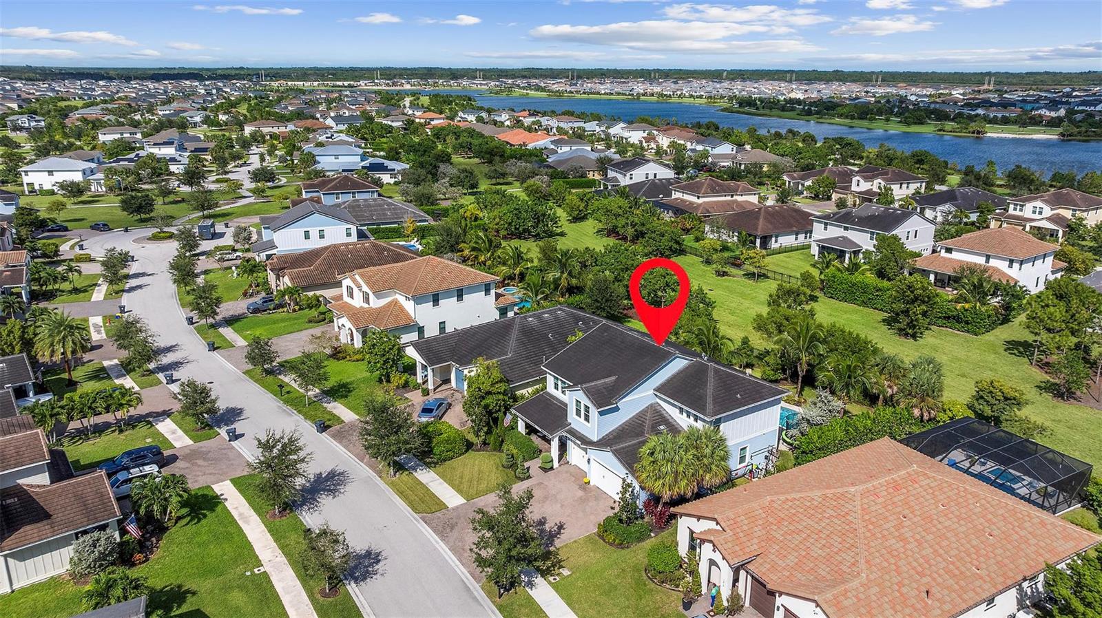 An aerial view shows a two-story suburban house with a red marker on its roof — 1018 Sweetgrass Street, Loxahatchee FL 33470, LOXAHATCHEE, FL