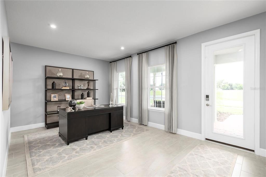 A home office features a dark desk, a tall shelving unit, and a glass-paneled door — 1658 W PALMS DRIVE, PORT CHARLOTTE, FL