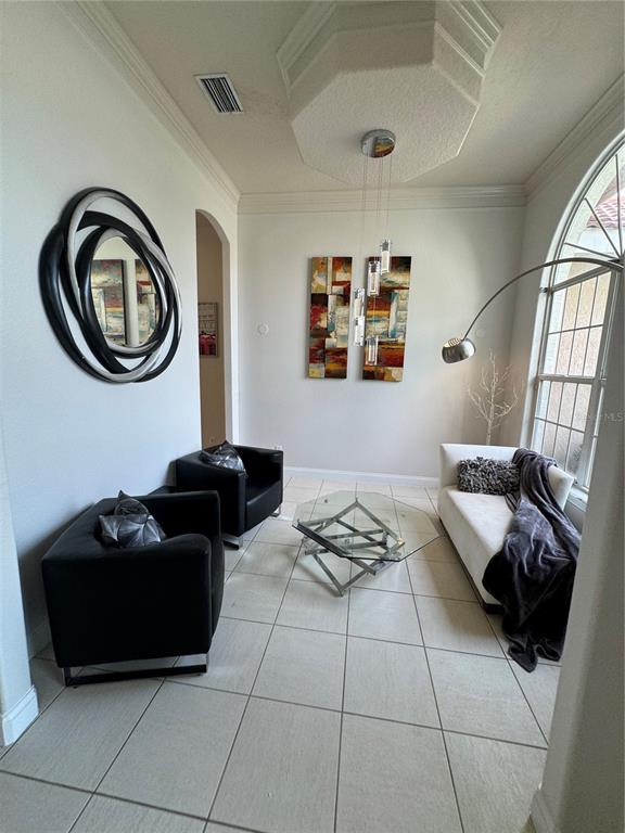 A living room features two black armchairs, a white sofa, and a glass coffee table — 9042 SHAWN PARK PLACE, ORLANDO, FL