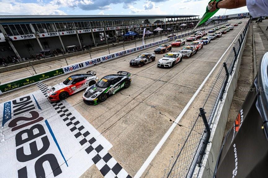 A high-angle view shows race cars lined up on a track at the Sebring circuit — 3700 SNYDER ROAD, SEBRING, FL