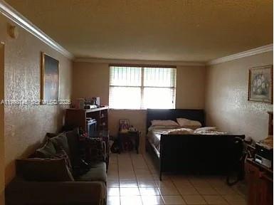 A bedroom with tiled floors, a bed, a sofa, and a window with blinds — 666 W 81st St # 124, Hialeah FL 33014, HIALEAH, FL