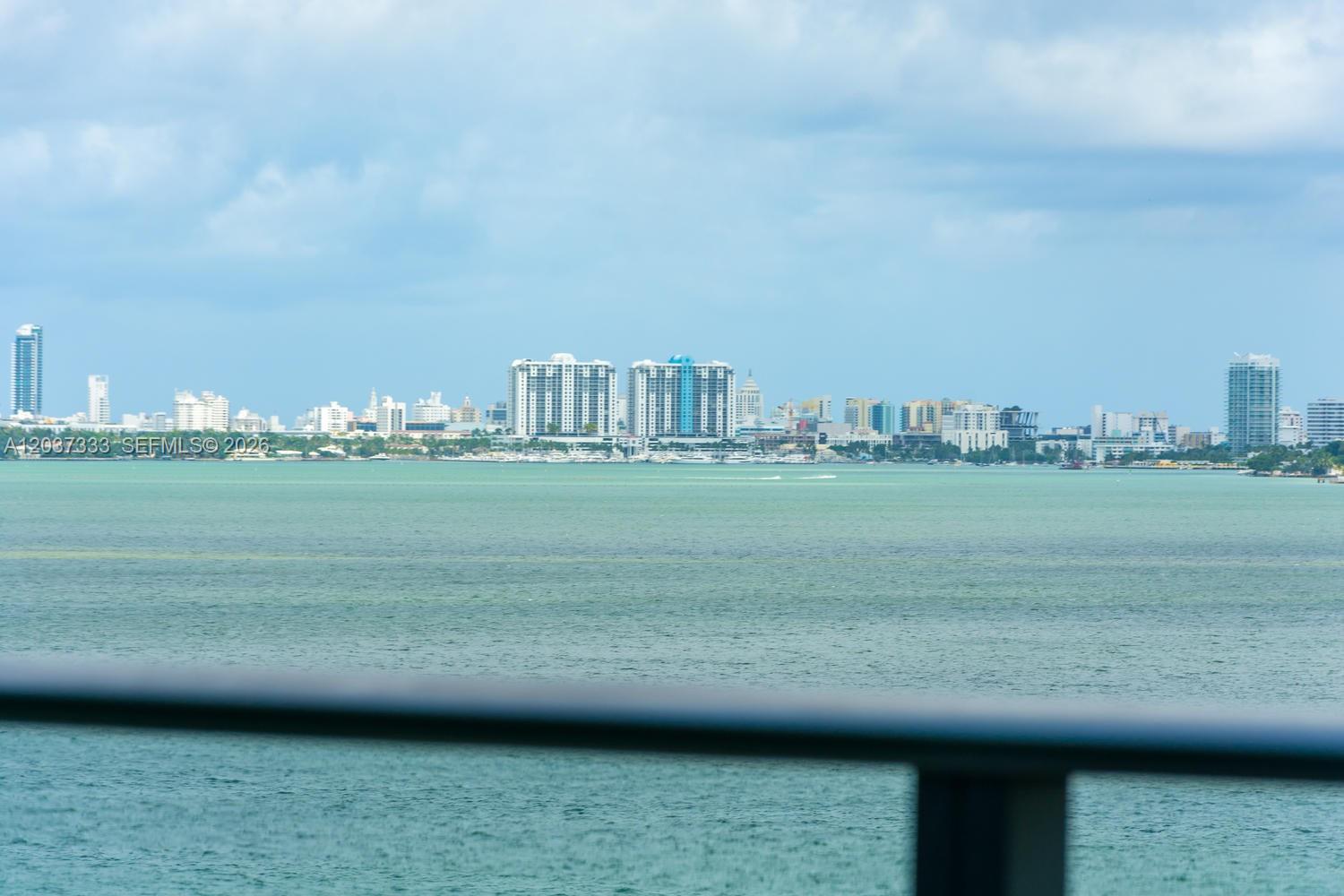 A view of a bay with a city skyline in the distance — 650 NE 32nd St # 805, Miami FL 33137, MIAMI, FL